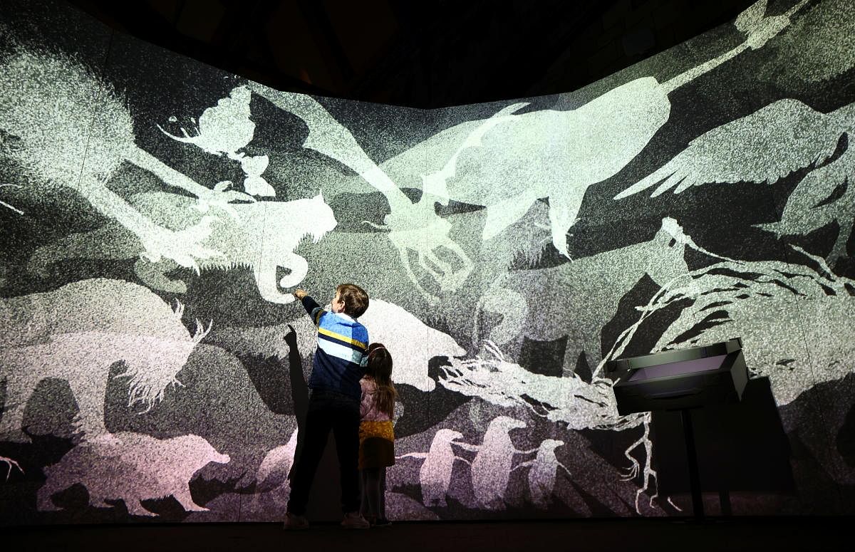 Two children look at an animated display, part of the 'Fantastic Beasts: The Wonder of Nature' exhibition opening soon at the Natural History Museum in London. Credit: Reuters