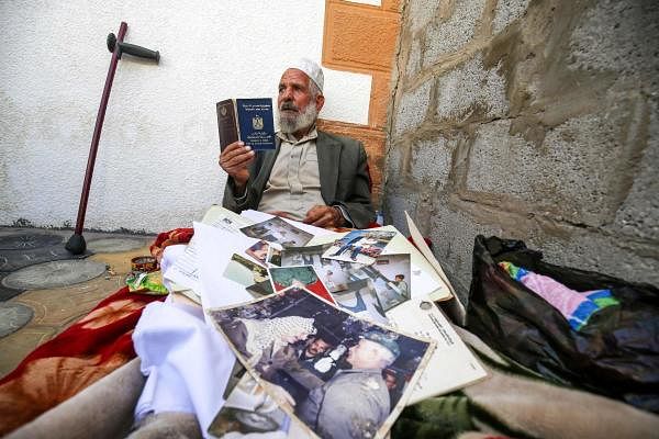 Iranian Qasem Sheyasi holds his Iranian and Egyptian travel documents in his house in Khan Yunis in the southern Gaza Strip. He used to be longtime Palestinian leader Yasser Arafat's bodyguard and he made quite clear that he is no longer in Gaza by choice. Credit: AFP