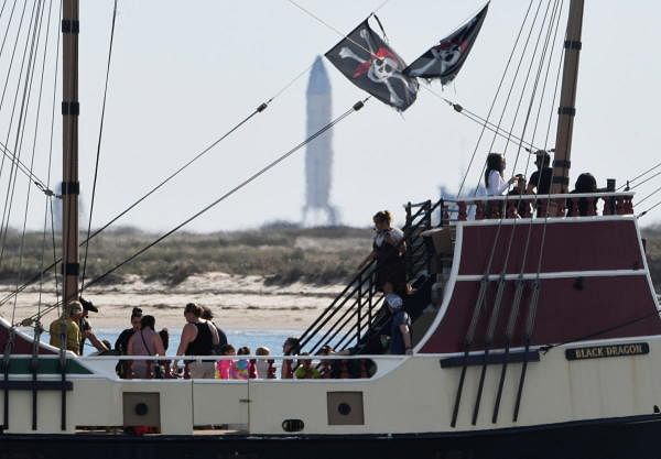 Tourists on a pirate ship pass in front of the SpaceX's Starship SN8 after the launching was aborted 1.3 seconds before ignition from their facility in Boca Chica, Texas, US. Credit: Reuters
