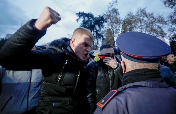 A demonstrator gestures in front of a police officer during a protest in reaction to the death of Klodian Rasha, after he was shot dead during the country's overnight curfew, in Tirana, Albania. Credit: Reuters