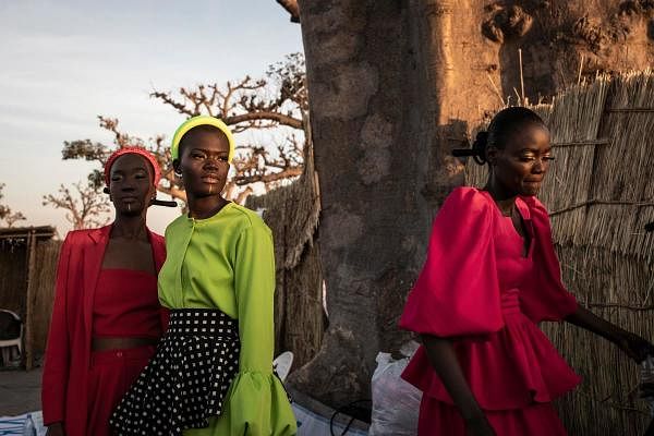 Fashion models get dresses fitted ahead of the start of Dakar Fashion Week in Dakar, Senegal. Credit: AFP