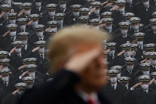 US Navy cadets wearing protective masks salute as US President Trump stands onto the field at Michie Stadium ahead of the annual Army-Navy collegiate football game, in West Point, New York, US. Credit: Reuters