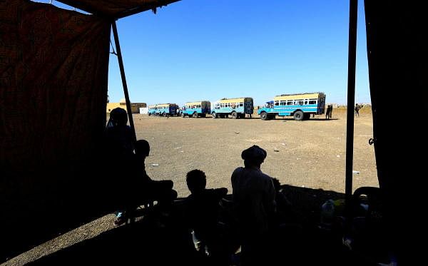 Ethiopian refugees who fled Tigray region, wait to board courtesy buses at the Fashaga camp as they are transferred to Um-Rakoba camp on the Sudan-Ethiopia border, in Kassala state, Sudan. Credit: Reuters