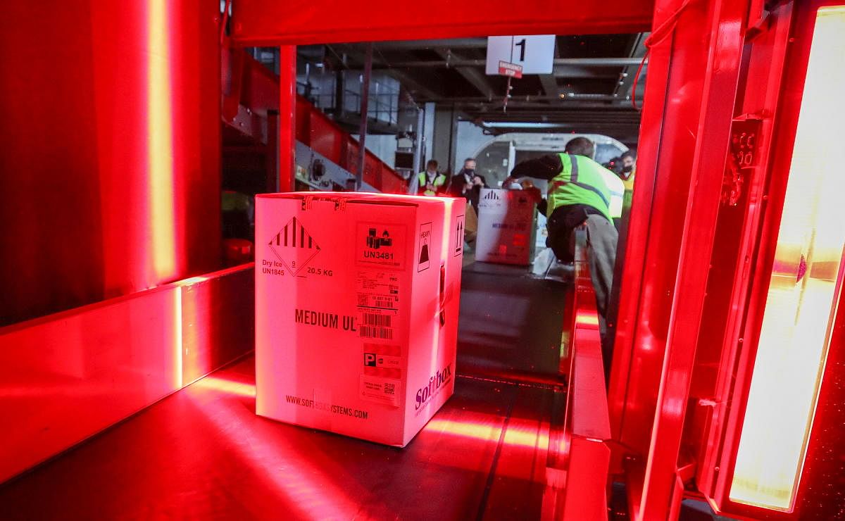Boxes containing Pfizer's Covid-19 vaccine are unloaded from air shipping containers and scanned at UPS Worldport, in Louisville, Kentucky. Credit: Reuters