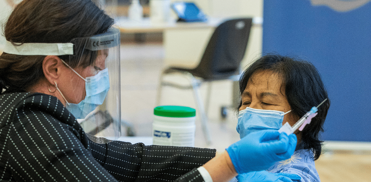 A healthcare worker administers a Pfizer/BioNTEch coronavirus disease vaccine to personal support worker Anita Quidangen at The Michener Institute, in Toronto. Credit: Reuters