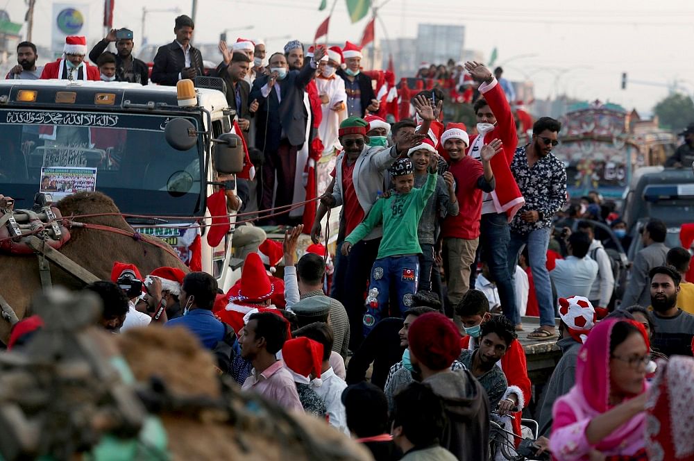 Christians, some wearing Santa Claus suits, participate in a Christmas celebration rally, in Karachi, Pakistan. Credit: AP Photo