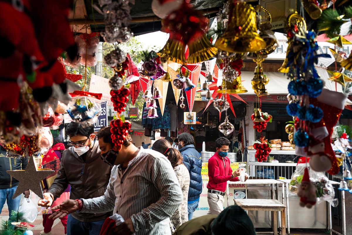 People buy Christmas decorations from a stall at a market in New Delhi on December 23, 2020. Credit: AFP Photo
