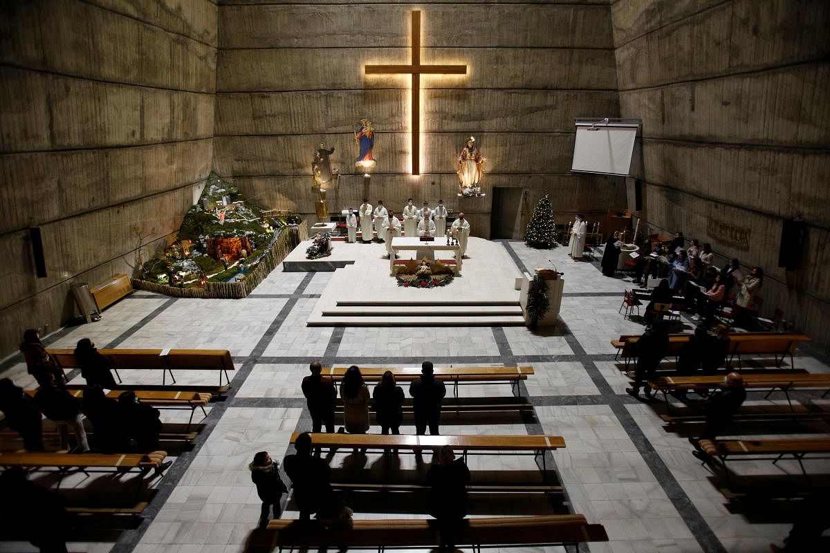 Worshippers attend a Christmas midnight mass at the Catholic church of the Holy Heart of Jesus as authorities lifted curfew and allowed religious services with protective measure against Covid-19 in Podgorica, Montenegro. Credit: Reuters