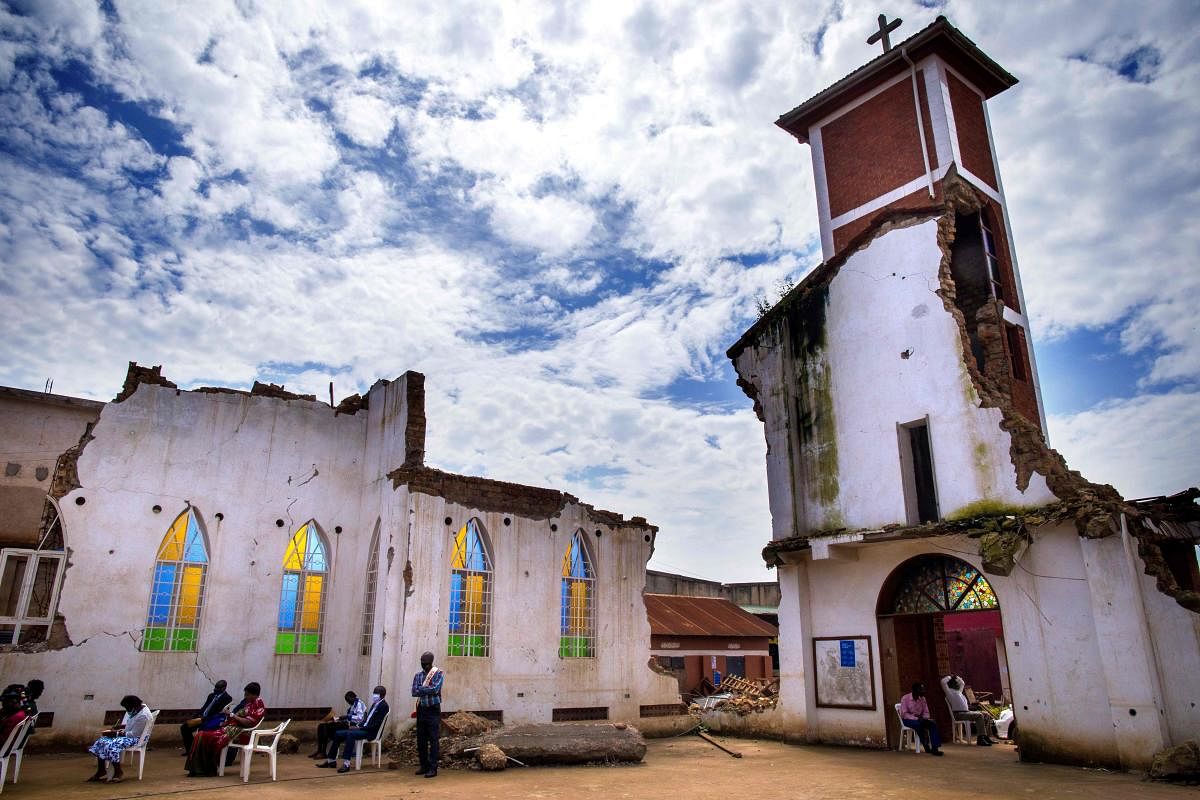 Believers attend their Christmas prayer at St. Peter's Church, which was demolished four months ago over ownership of the land and now is on trial, in Kampala, Uganda. Credit: AFP
