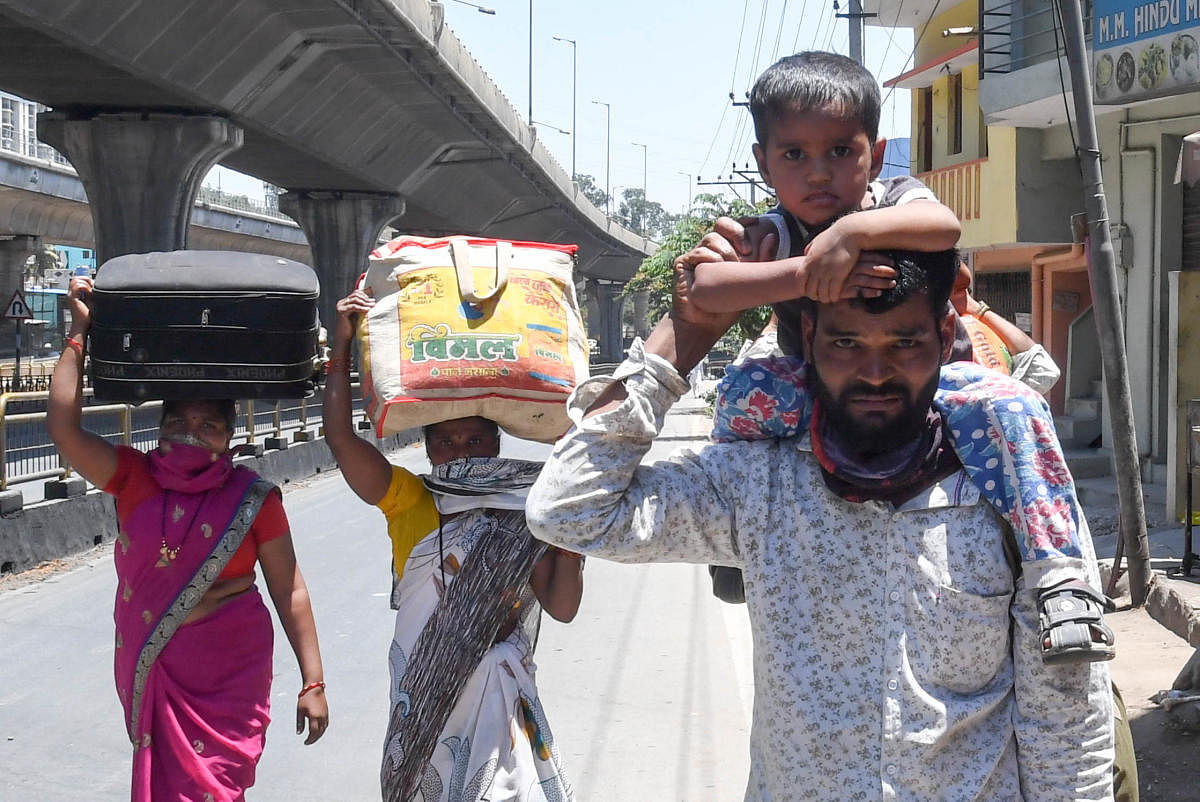 The Exodus of migrants | A migrant worker and his family members walk along a road as they leave the city for their home in Vijayapura, days after the government imposes a 21-day nationwide lockdown as a preventive measure against the coronavirus. Credit: DH Photo/ BH Shivakumar