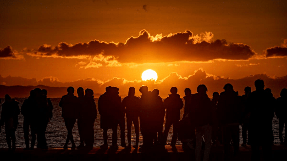 People gather at Southern Beach of Chigasaki to watch the sunrise on New Year's Day in Kanagawa Prefecture, southwest of Tokyo. Credit: AFP