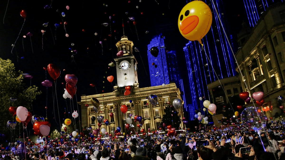 People hold balloons as they gather to celebrate the arrival of the new year during the Covid-19 outbreak in Wuhan, China. Credit: Reuters