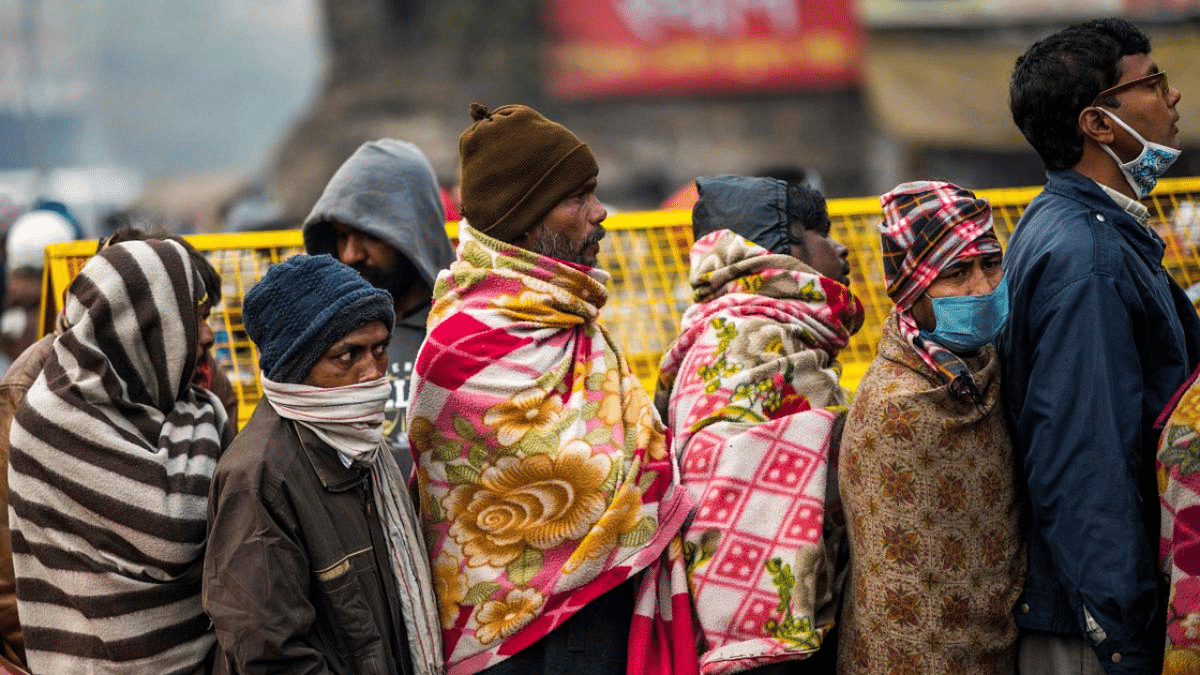 People line up to get free breakfast outside a temple during a cold winter morning in New Delhi. Credit: AFP