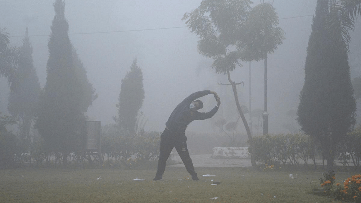 A man does exercises at a park amid dense fog, in Jalandhar. Credit: PTI
