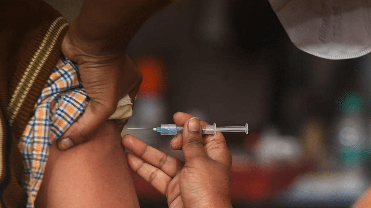 A health official (L) prepares to administer a vaccine during a dry run or a mock drill for Covid-19 coronavirus vaccine delivery at a primary health centre in Kolkata. Credit: AFP Photo