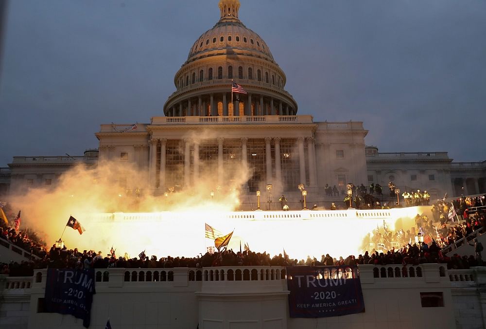 An explosion caused by a police munition is seen while supporters of US President Donald Trump gather in front of the US Capitol Building. Credit: Reuters Photo