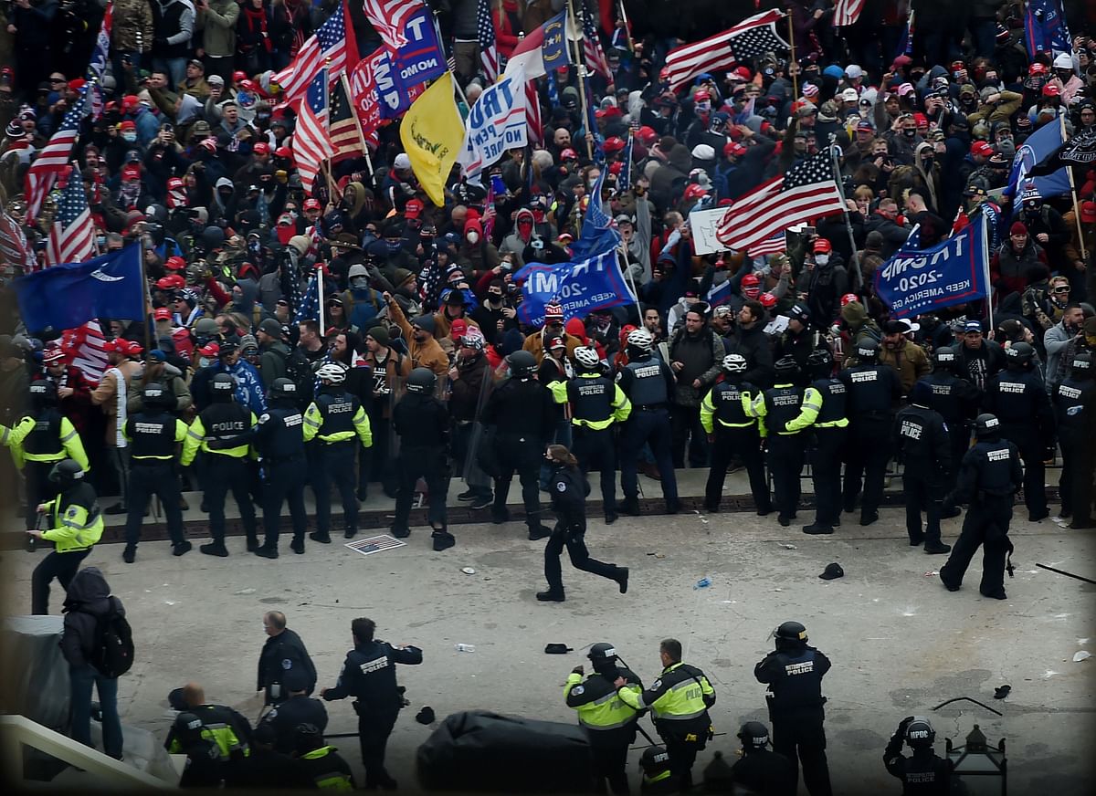 Police hold back supporters of US President Donald Trump as they gather outside the US Capitol's Rotunda. Credit: AFP Photo