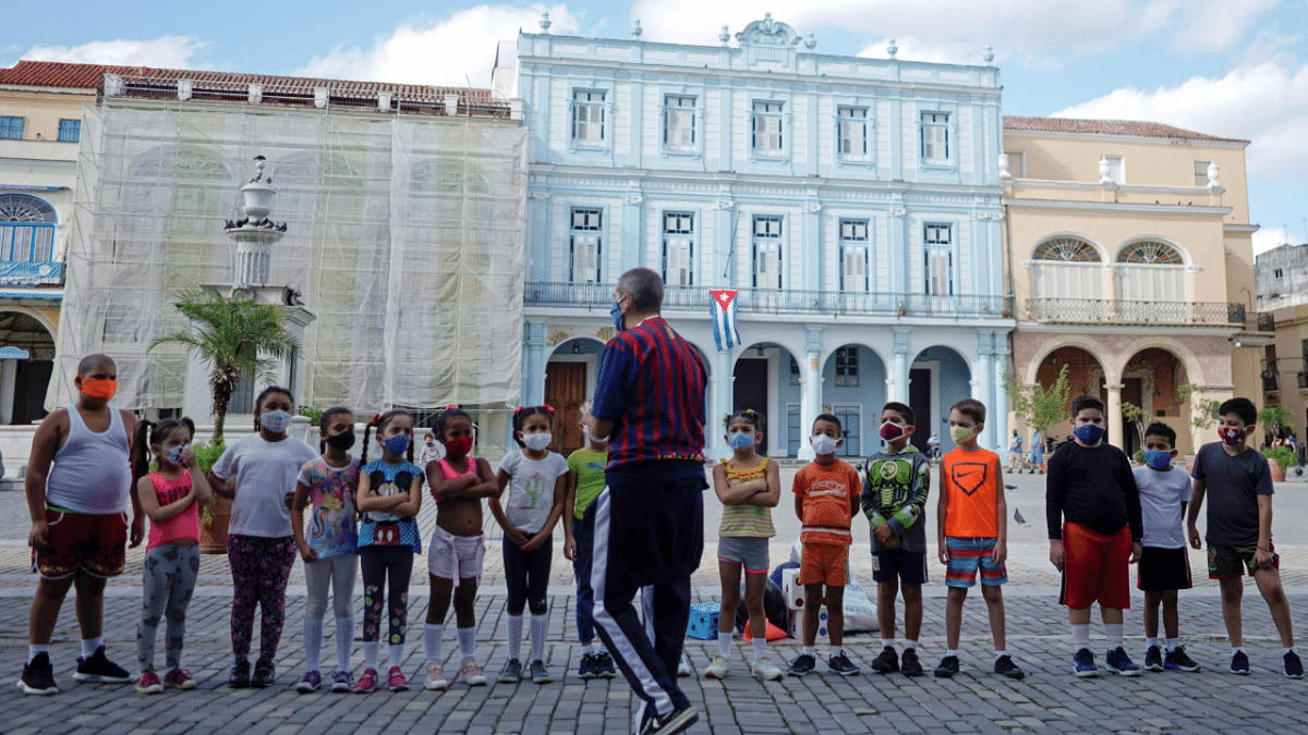 Children listen to their teacher amid concerns about the spread of Covid-19, in Havana, Cuba. Credit: Reuters Photo