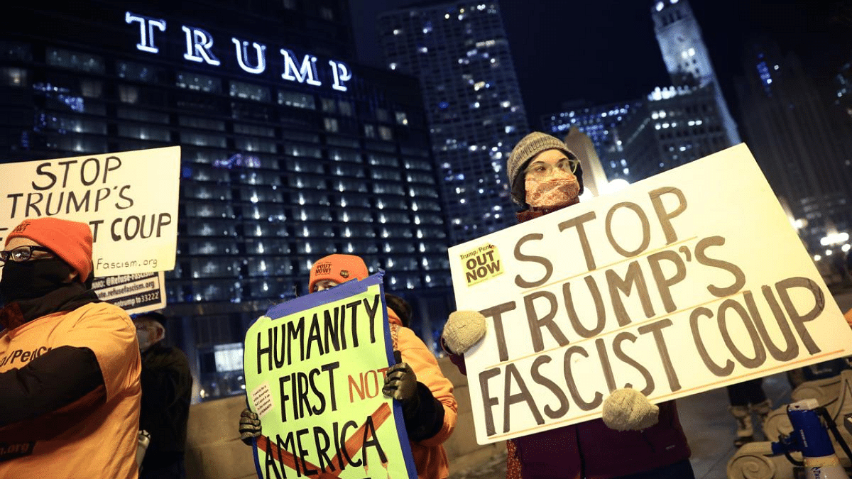 A small group of demonstrators protest near Trump Tower in Chicago, Illinois, calling for President Donald Trump's removal from office after the Capitol Building violence that took place yesterday in Washington. Credit: AFP Photo