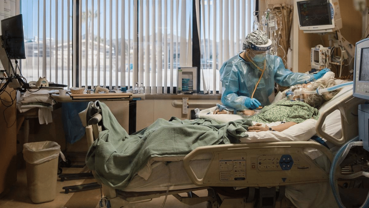 A Registered Nurse tends to a Covid-19 patient in the Intensive Care Unit at Providence St. Mary Medical Center in Apple Valley, California. Credit: AFP Photo