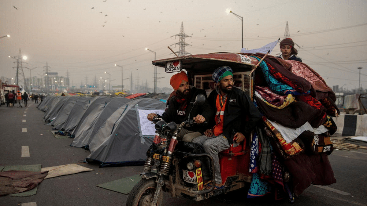 Farmers transport blankets and mattresses at the site of a protest against new farm laws, at the Delhi-Uttar Pradesh border in Ghaziabad, India. Credit: Reuters Photo