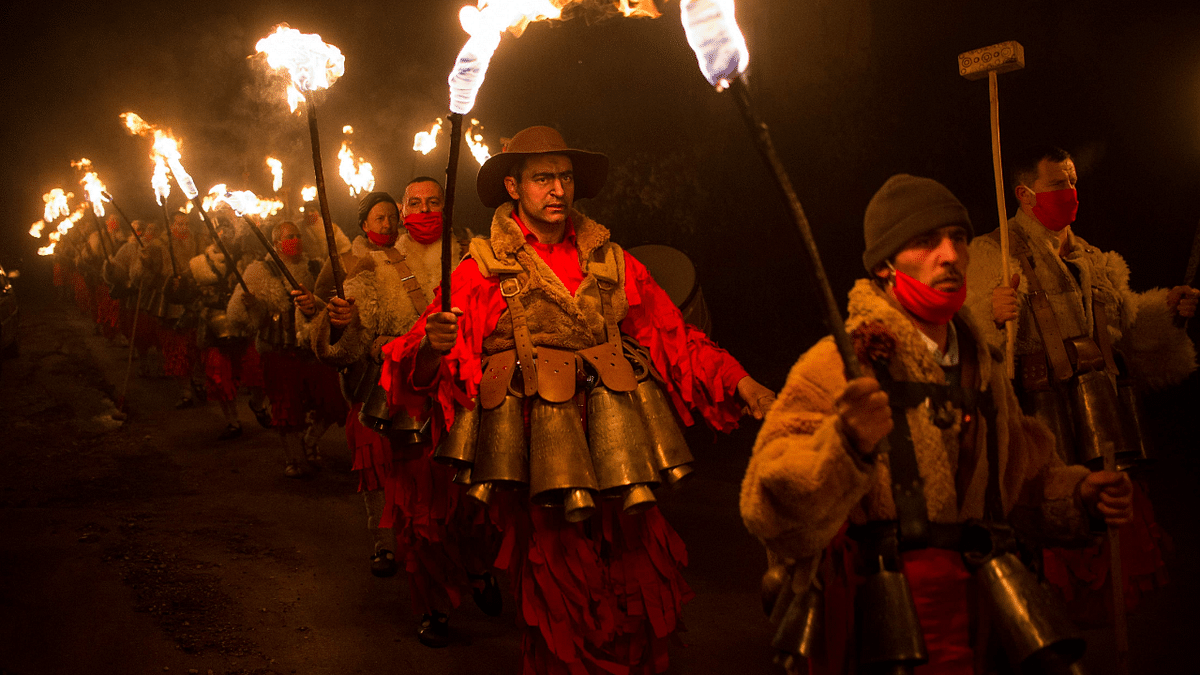 Bulgarian dancers wearing costumes perform a ritual dance with flaming torches during the Kukeri Carnival in the village of Dolna Sekirna, western Bulgaria. Credit: AFP Photo
