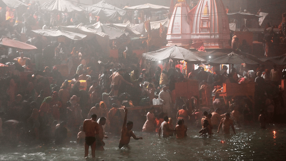 Hindu devotees take a holy dip in the waters of river Ganges during Makar Sankranti, a day considered to be of great religious significance in Hindu mythology, on the first day of the religious Kumbh Mela festival in Haridwar. Credit: AFP Photo