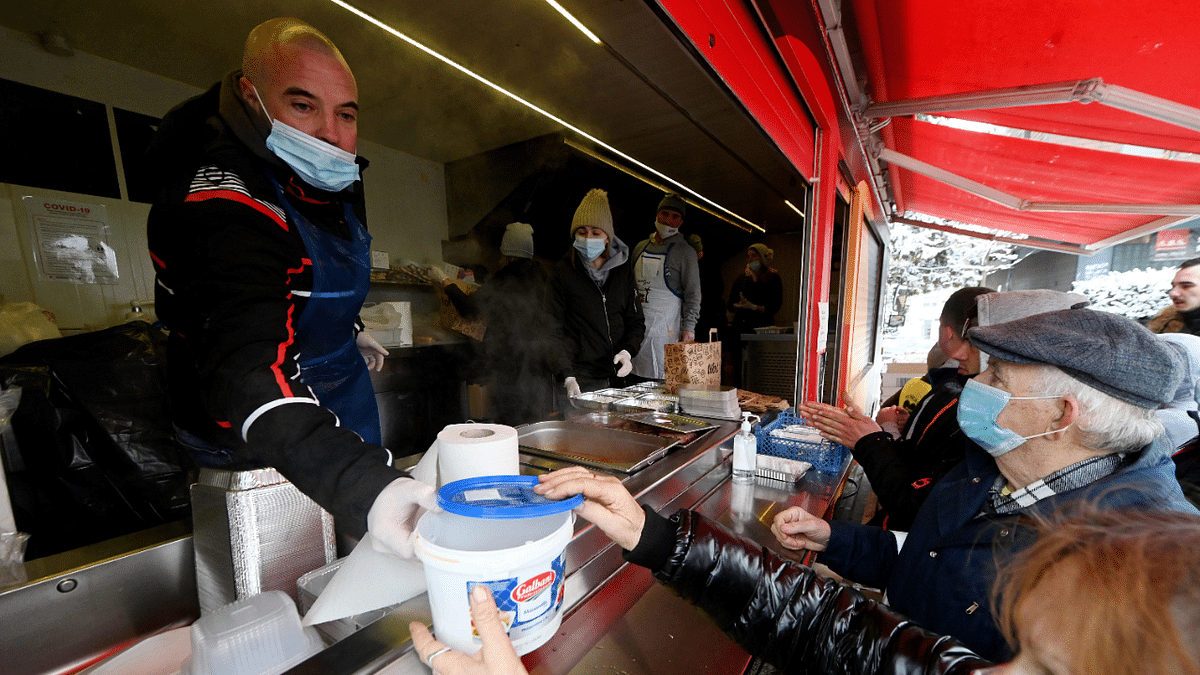 Volunteers at a food truck at a square in Petrinja distribute hot meals, prepared by Croatian chefs, to people affected by a deadly quake on December 29. Credit: AFP Photo