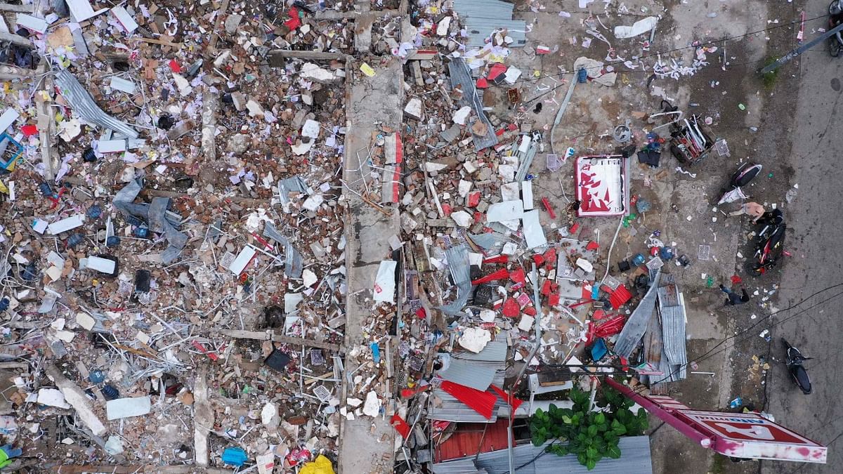 This aerial picture shows a shop damaged following a 6.2 magnitude earthquake in Mamuju, Indonesia. Credit: AFP Photo