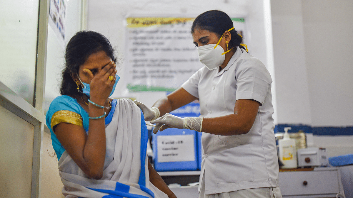 A medic administers the first dose of Covishield vaccine to a frontline worker, after the virtual launch of Covid-19 vaccination drive by Prime Minister Narendra Modi, at a health center in Visakhapatnam. Credit: PTI Photo