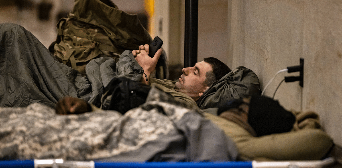 National Guard soldiers rest on cots in the Visitors Center of the US Capitol on January 17, 2021 in Washington, DC. After last week's riots at the US Capitol Building, the FBI has warned of additional threats in the nation's capital and in all 50 states. Credit: AFP Photo