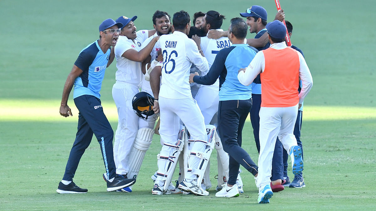 T Natarajan and Prithvi Shaw among other staff rush on to the field celebrating the series win. Credit: Reuters Photo