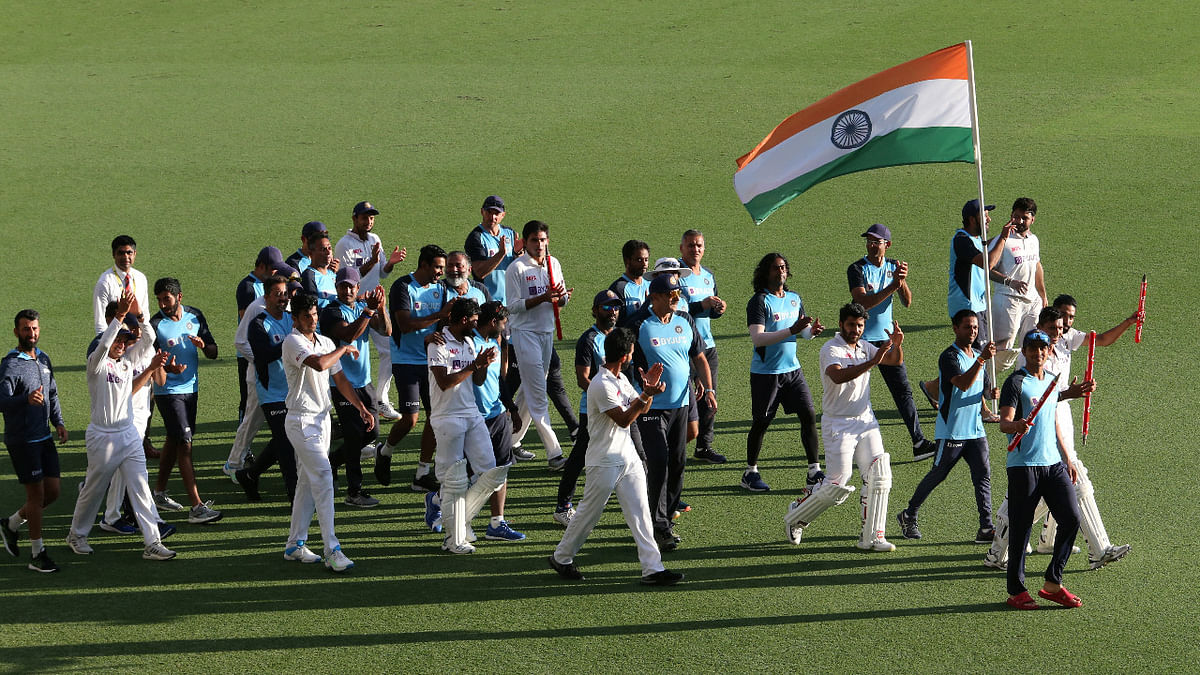 The Indian team takes a victory lap of the Gabba with the Indian flag after winning the Border-Gavaskar Trophy. Credit: Reuters Photo