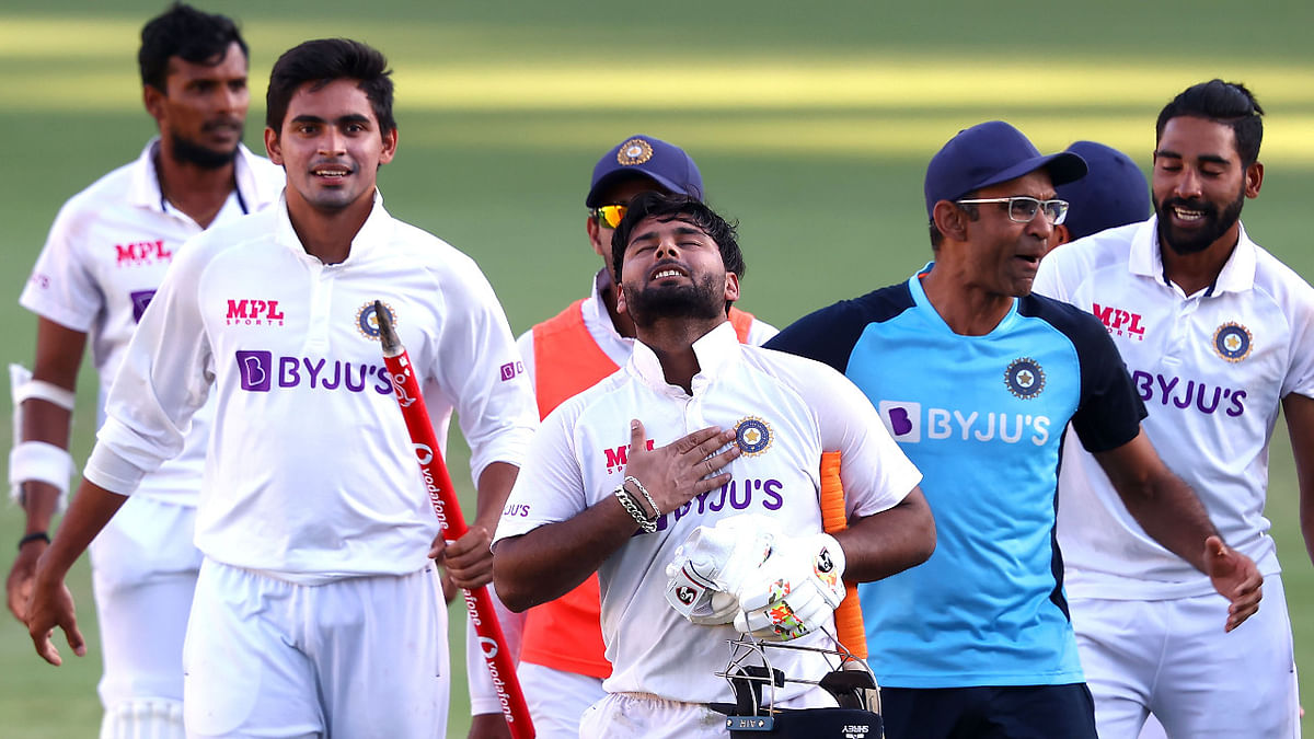 Rishabh Pant (C) gestures as team celebrate victory. Credit: AFP Photo