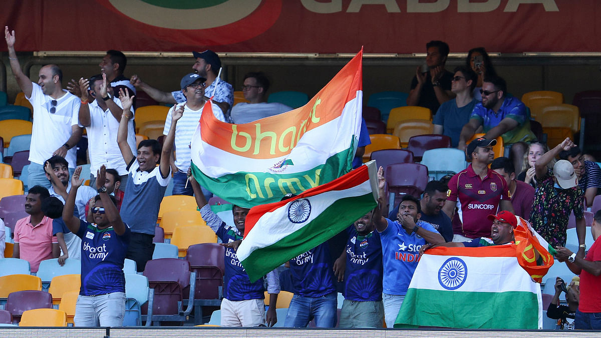 Indian fans celebrate after defeating Australia in a historic series win after several players were injured. Credit: AP Photo