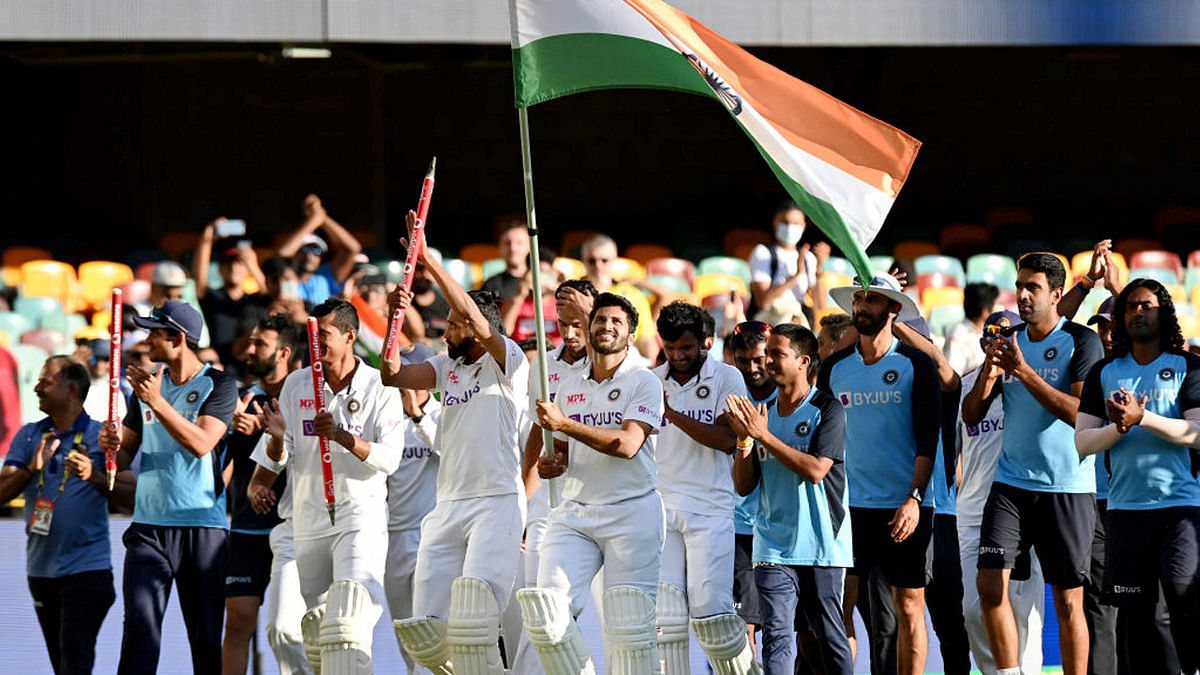 Shardul Thakur carries the Indian flag during the victory lap at the Gabba. Credit: Twitter Photo/BCCI