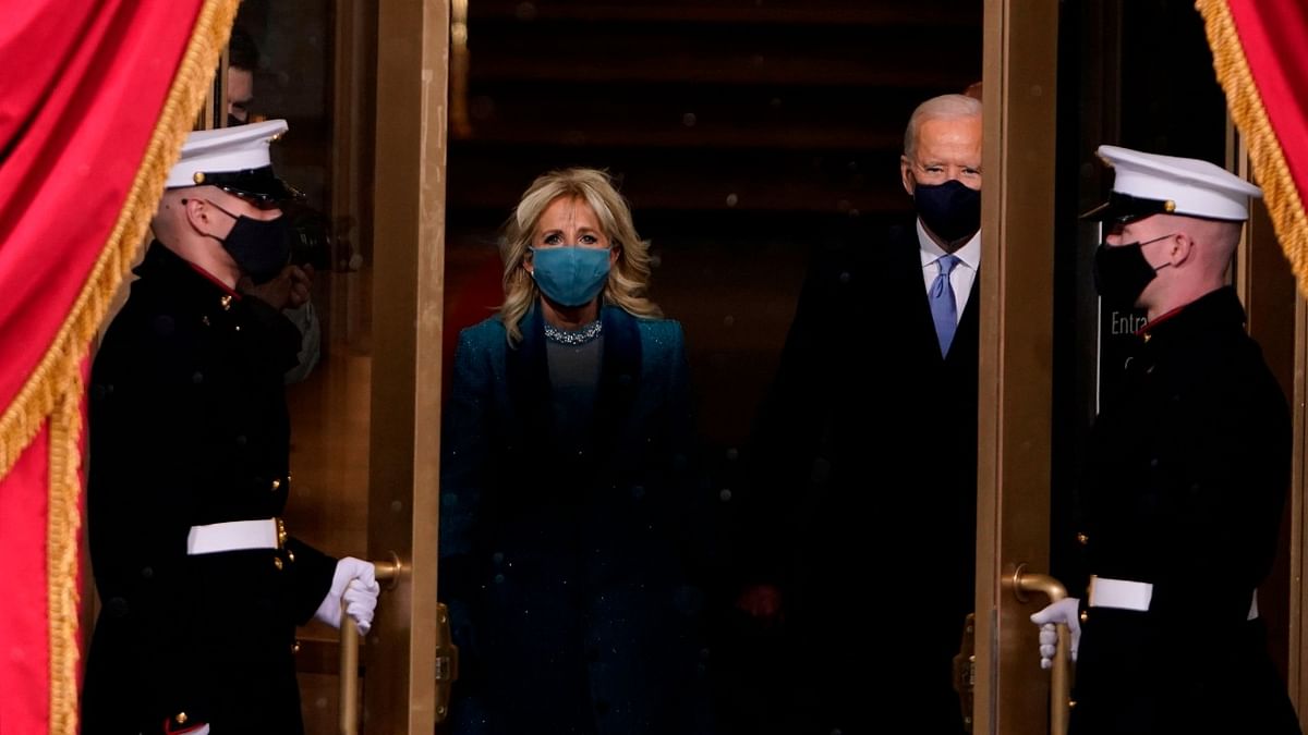 US President-elect Joe Biden flanked by wife Dr Jill Biden arriving for his inauguration as the 46th US President on January 20, 2021, at the US Capitol in Washington, DC. Credit: AFP Photo