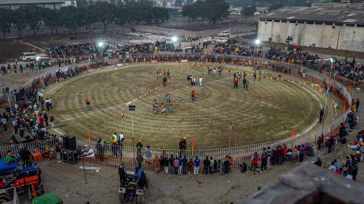 Farmers watch a Kabaddi match at Singhu border during their 'Delhi Chalo' protest march against the Centre's new farm laws, in New Delhi. Credit: PTI Photo