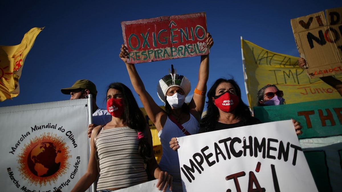 Demostrators take part in a protest against Brazil's President Jair Bolsonaro and his handling of the Covid-19 outbreak in Brasilia, Brazil. Credit: Reuters Photo.