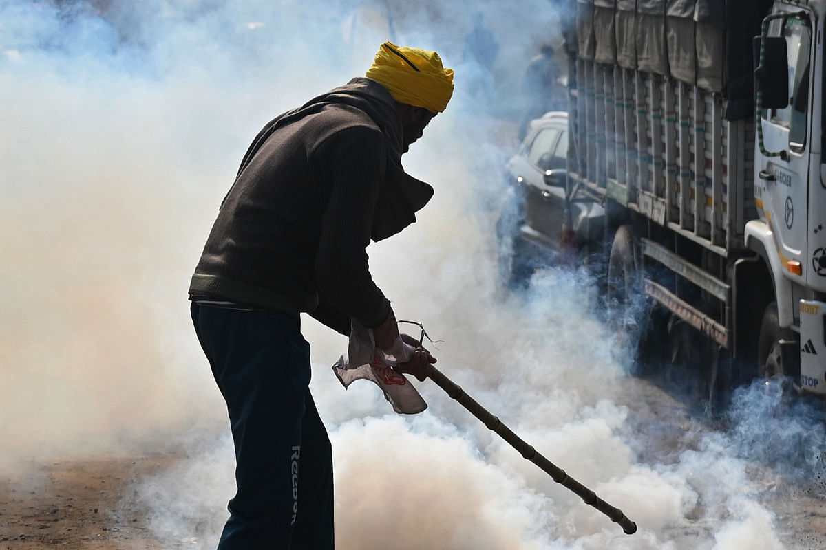 Clashes broke out between police and protesting farmers after the latter reached ITO and tried to push towards Lutyen's Delhi, prompting the force to use lathi-charge and tear gas shells against them. Credit: AFP