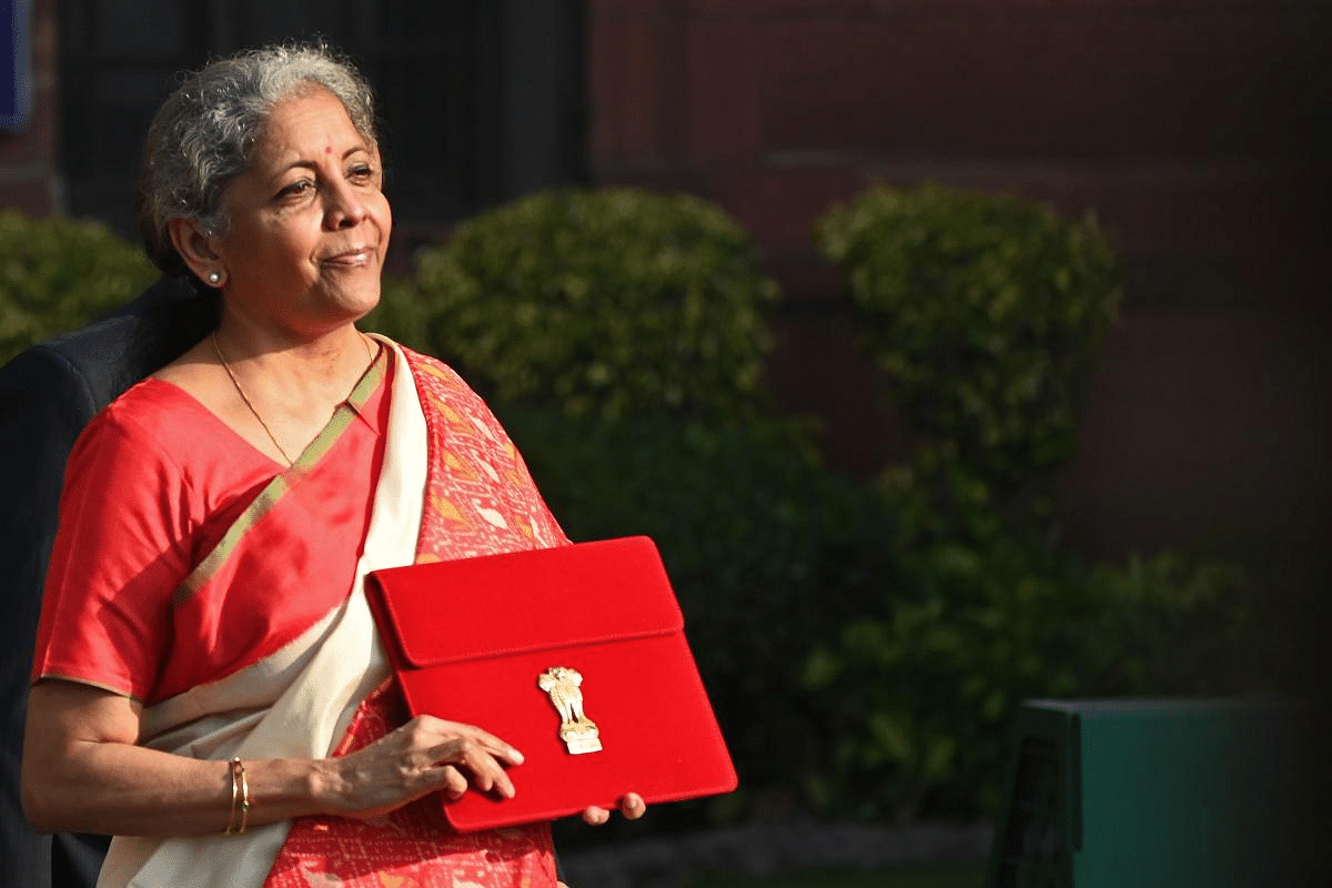 Finance Minister Nirmala Sitharaman poses for pictures as she leaves the Finance Ministry to present the annual budget in parliament in New Delhi on February 1, Credit: AFP Photo