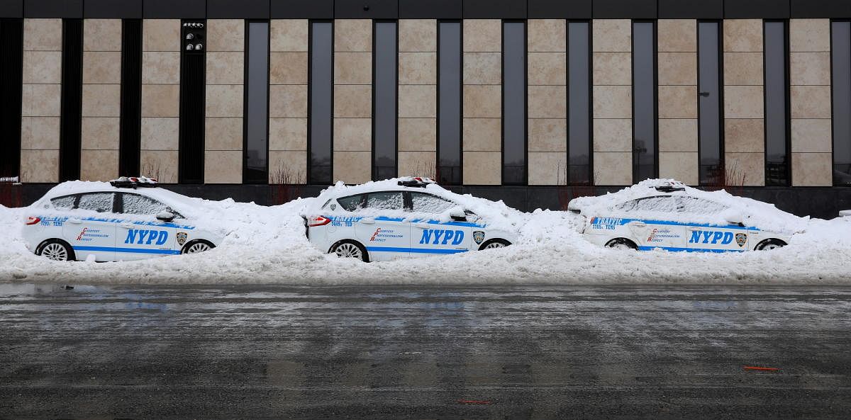 New York Police Department (NYPD) vehicles are seen buried in snow in Manhattan, New York City February 2, 2021. Credit: REUTERS