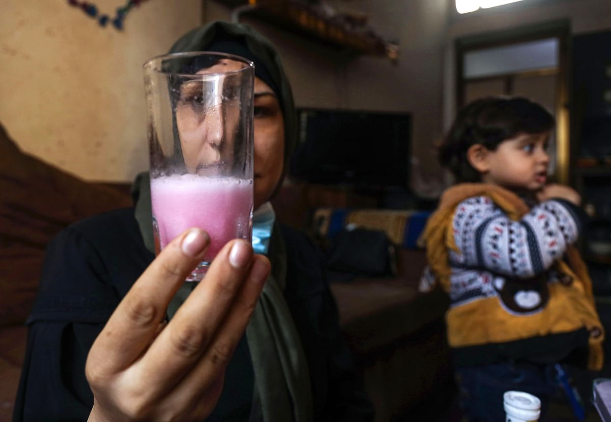 Tahani al-Rifi, a 34-year-old Palestinian thyroid cancer patient, takes her medicine at home in Gaza City on February 1, 2021, amid restrictions imposed during the pandemic which have made travelling for treatment to a hospital in the West Bank impossible for her. - Gaza, a Mediterranean enclave controlled by the Hamas Islamist group since 2007, had a weak healthcare system before the coronavirus pandemic, due partly to an Israeli-enforced blockade. Israel tightly controls the flow of goods and people in and out of Gaza, measures it says are necessary to contain Hamas and other jihadist groups in the strip. Credit: AFP Photo