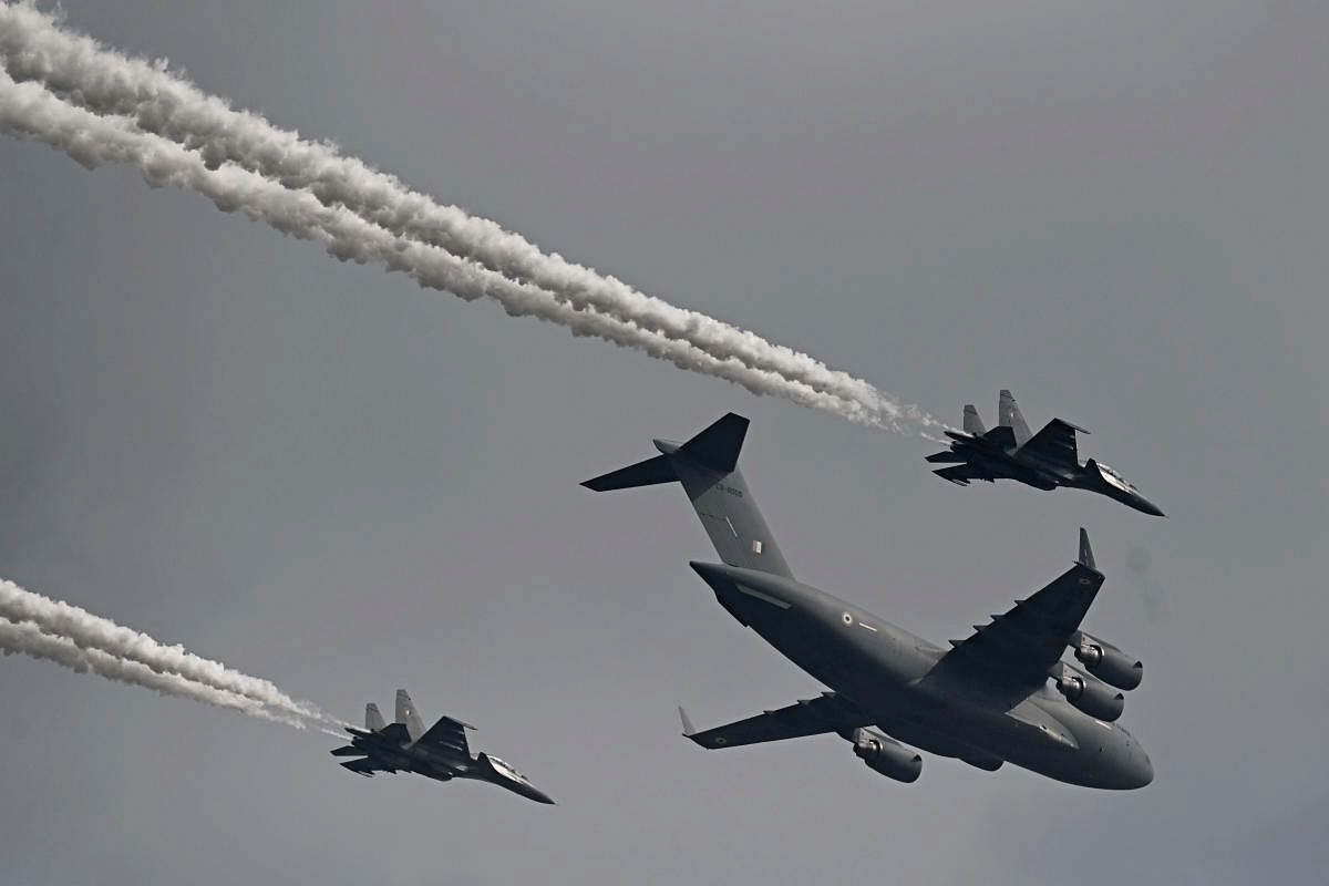 Indian Air Force's C-17 Globemaster (C) along with Sukhoi Su-30MKI fighter jets fly past during the first day of the Aero India 2021 Airshow at the Yelahanka Air Force Station in Bengaluru. Credit: AFP Photo