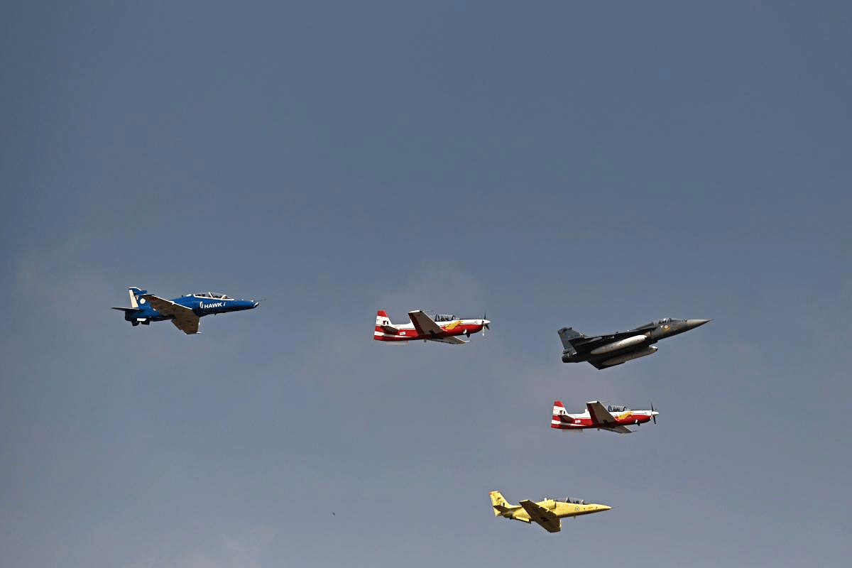Indian Air Force (IAF) aircrafts fly past during the first day of the Aero India 2021 Airshow. Credit: AFP Photo