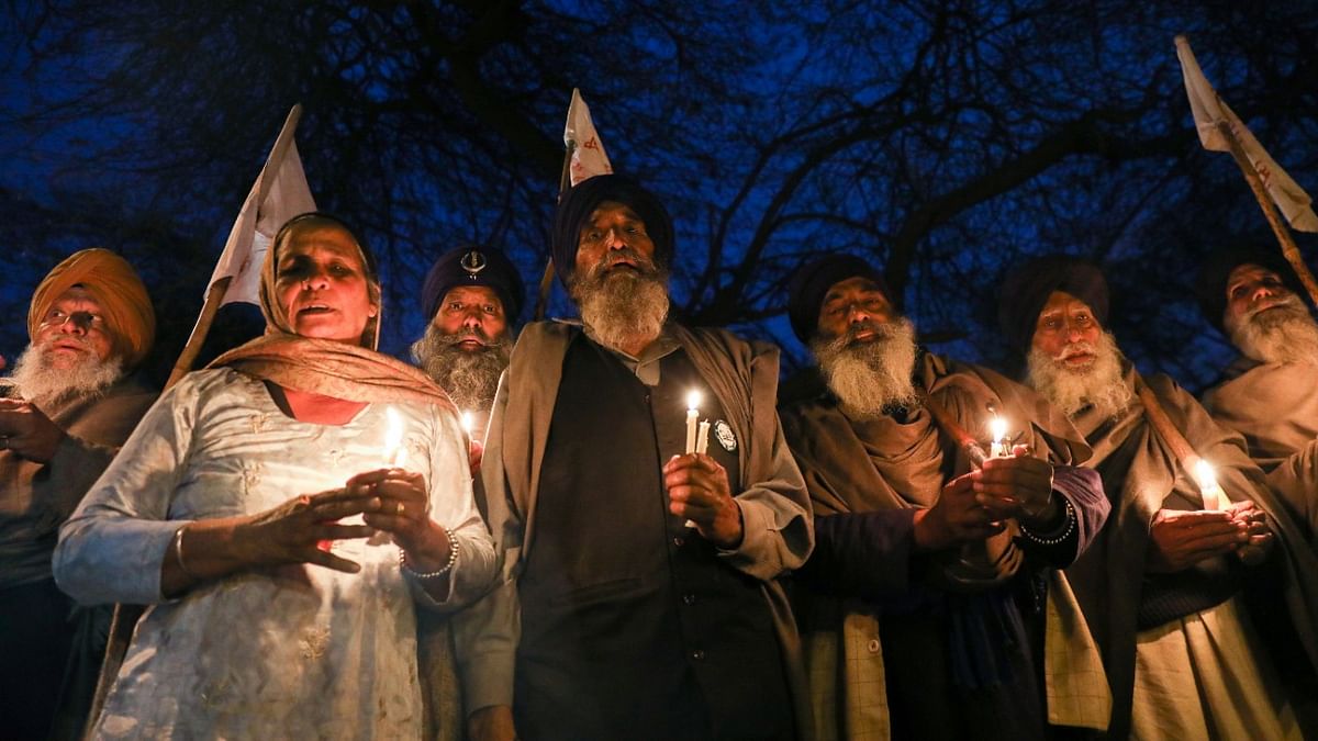 Farmers take part in a candlelit vigil, in memory of a person who died during a tractor rally on India’s Republic Day, as protests against farm laws continue, at Singhu Border near New Delhi, India. Credit: Reuters Photo