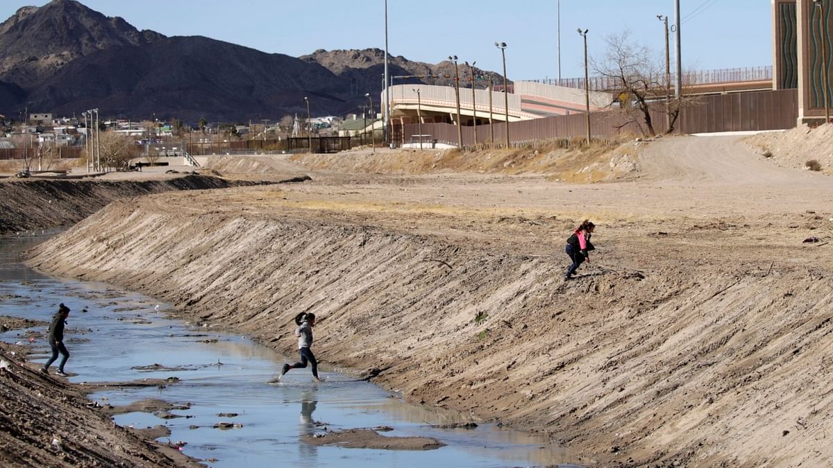 Migrants cross the Rio Bravo river to turn themselves in to request for asylum in El Paso, Texas, US, as seen from Ciudad Juarez, Mexico. Credit: Reuters Photo