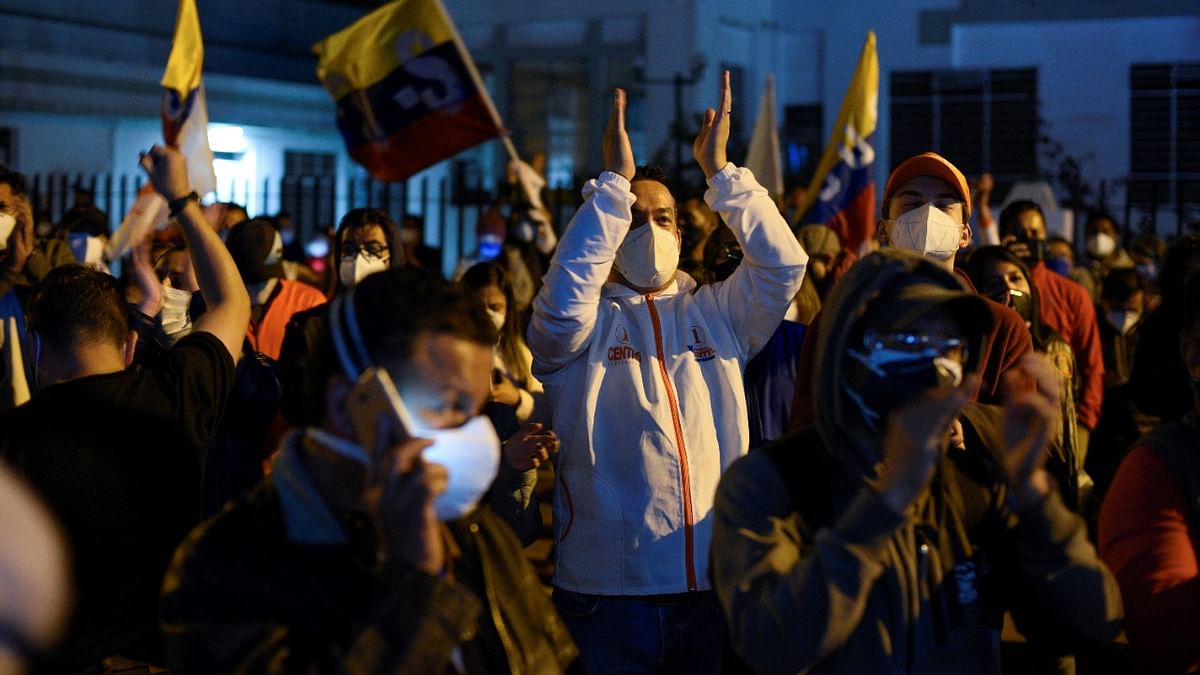 Supporters of Ecuador's presidential candidate Andres Arauz (not pictured) gather while waiting for official results of the presidential election, in Quito, Ecuador. Credit: AFP Photo.