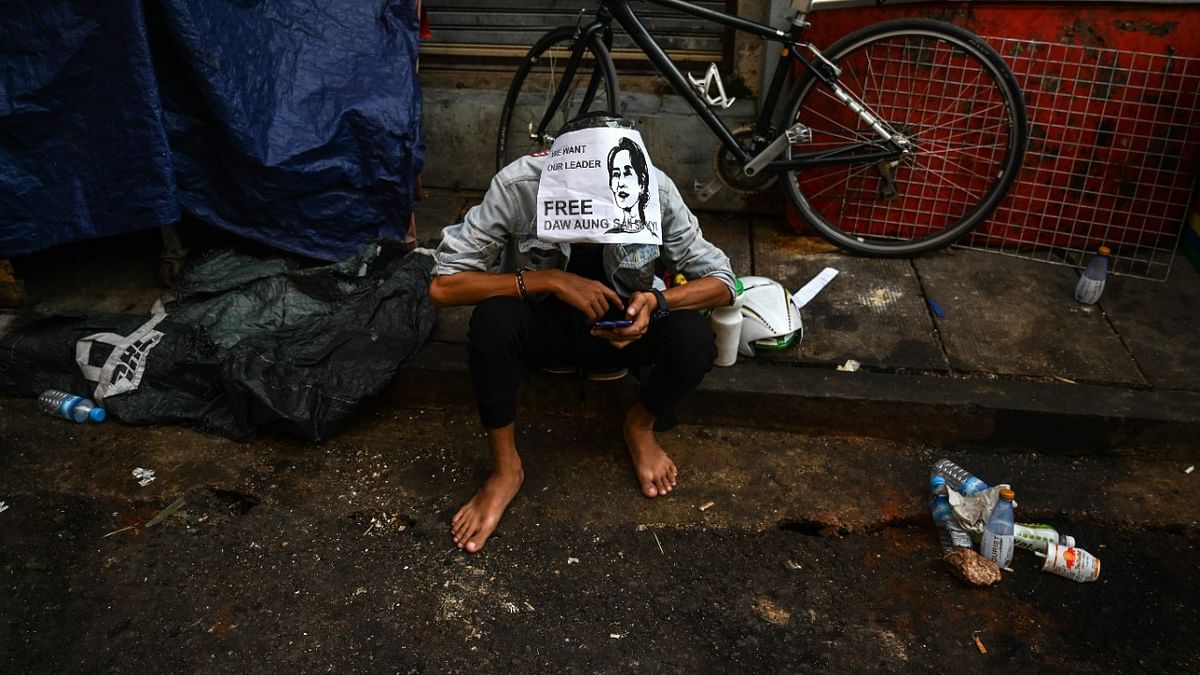 A protester wears a sign calling for the release of detained civilian leader Aung San Suu Kyi as they take part in a demonstration against the military coup in Yangon. Credit: AFP Photo.