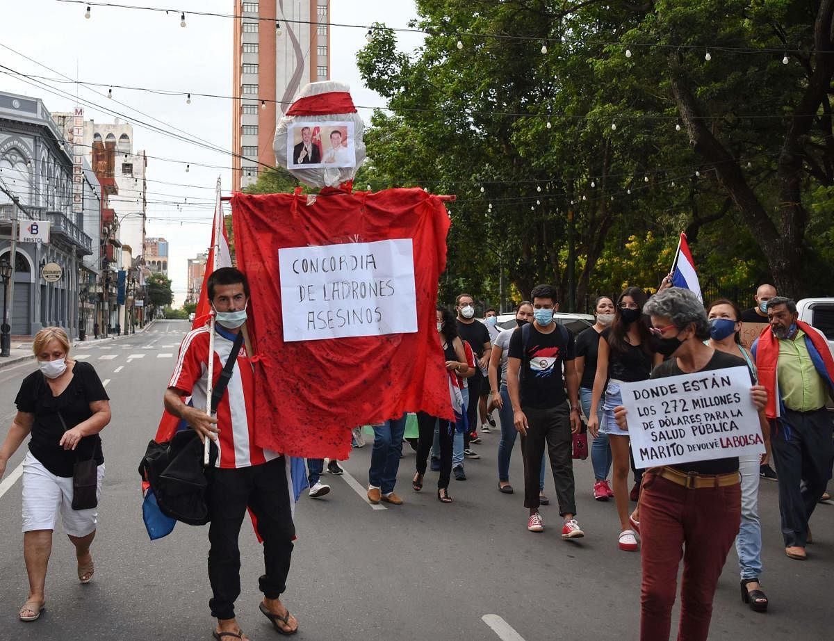 Demonstrators take part in a protest against the public education and health policies of the government of President Mario Abdo Benitez outside the ruling party's headquarters, in Asuncion, Paraguay. Credit: AFP photo.